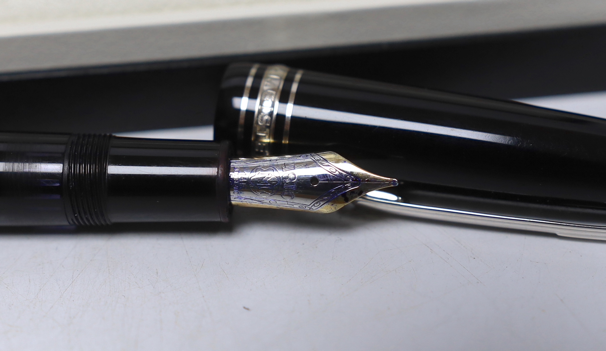 A Montblanc boxed ‘Meistertuck’ fountain pen and a leather cased Montblanc ballpoint pen, a spare box, etc.